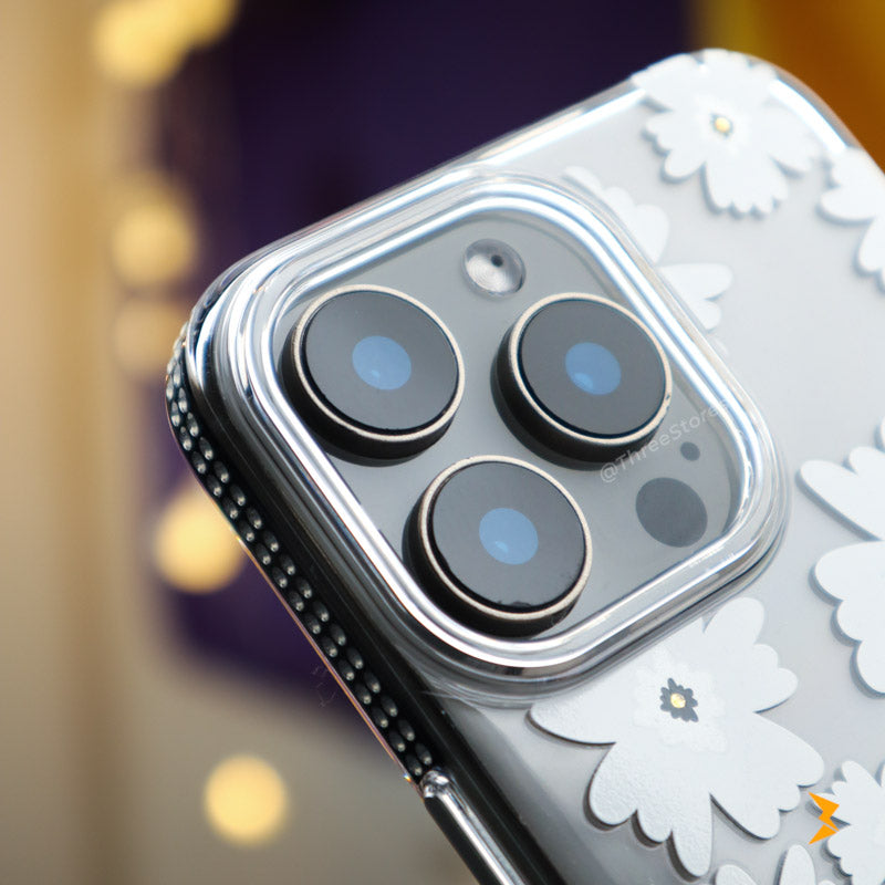 Close-up of a smartphone with camera lenses and floral case design.